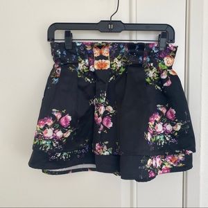 Silken like floral print black mini skirt
